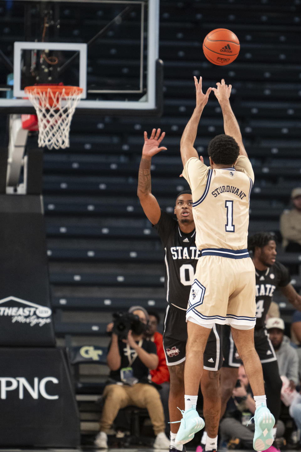 Georgia Tech guard Kyle Sturdivant (1) shoots a three pointer against Mississippi State forward D.J. Jeffries (0) in the first half of an NCAA college basketball game Tuesday, Nov. 28, 2023, in Atlanta. (AP Photo/Hakim Wright Sr.)