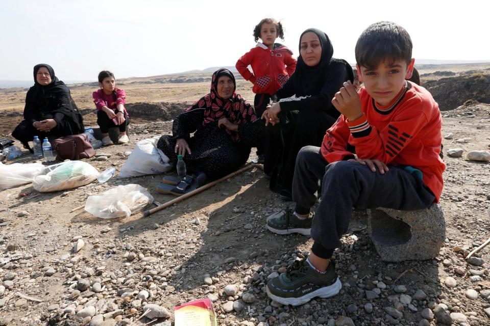 FILE PHOTO: Displaced Kurds stuck at a border after a Turkish offensive in northeastern Syria, wait to try cross to the Iraqi side, at the Semalka crossing, next Derik city, Syria, October 21, 2019. REUTERS/Muhammad Hamed/File Photo