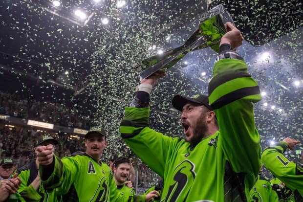 Saskatchewan Rush forward Mark Matthews celebrates with the National Lacrosse League Cup after defeating the Rochester Knighthawks in Saskatoon in 2018. (THE CANADIAN PRESS/Liam Richards - image credit)