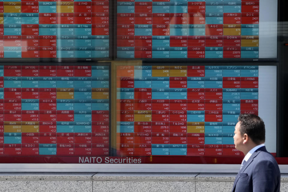 A man looks at an electronic stock board showing Japan's stock prices at a securities firm on April 4, 2023 in Tokyo. Asian stock markets followed Wall Street higher on Friday, April 7, ahead of a U.S. job market update that traders hope might encourage the Federal Reserve to ease off plans for more interest rate hikes.(AP Photo/Shuji Kajiyama)