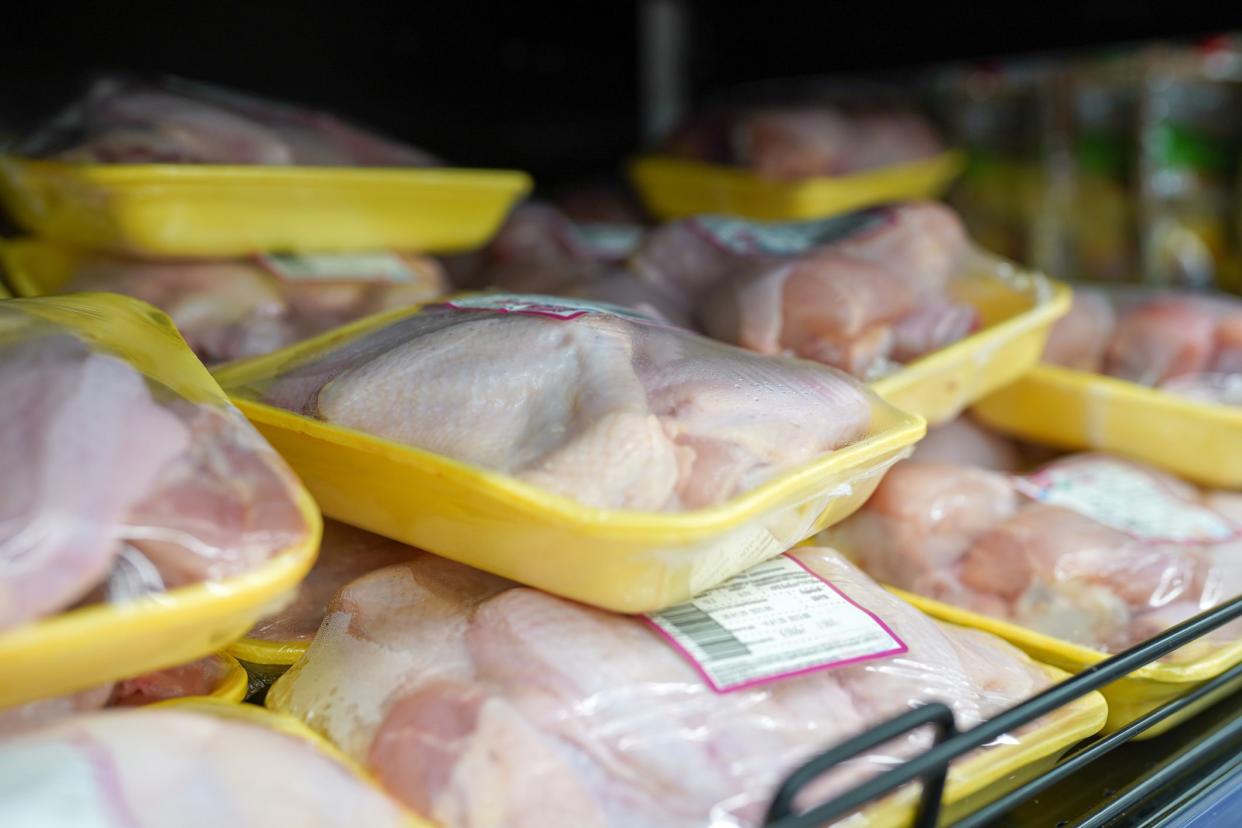 Fully loaded shelves with chicken meat in large supermarket