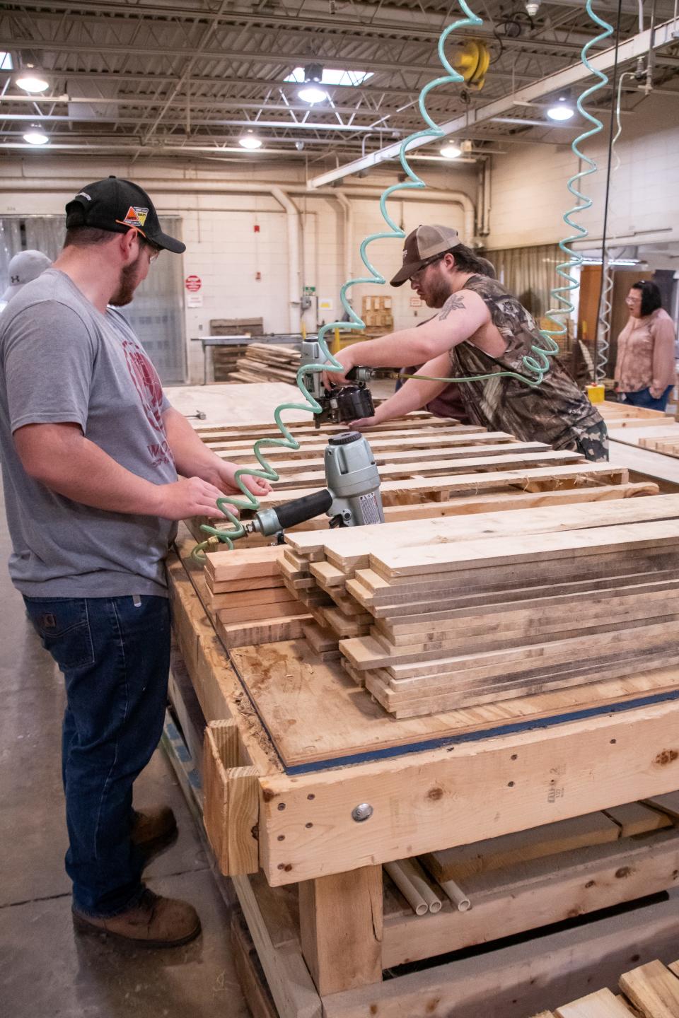 Marcus Warden, left and David Peoples build pallets for local businesses at Guernsey Industries.