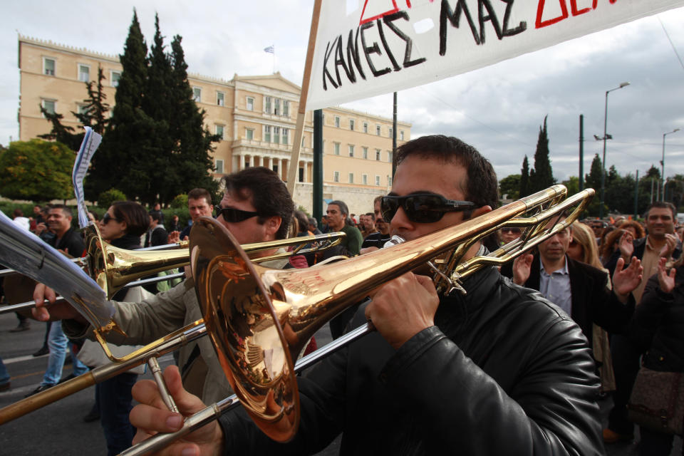 Members of Athens municipal brass band play their instruments during a protest in front of the Greek parliament on Tuesday, Nov. 20, 2012. About 2,500 people took part in the protest, against government plans to place 2,000 civil servants on notice ahead of reassignment or potential dismissal. Greece faces a tense wait Tuesday for vital bailout money as finance ministers from the 17 European Union countries that use the euro try to reach an agreement on how to put the country's economic recovery back on the right track. (AP Photo/Thanassis Stavrakis)