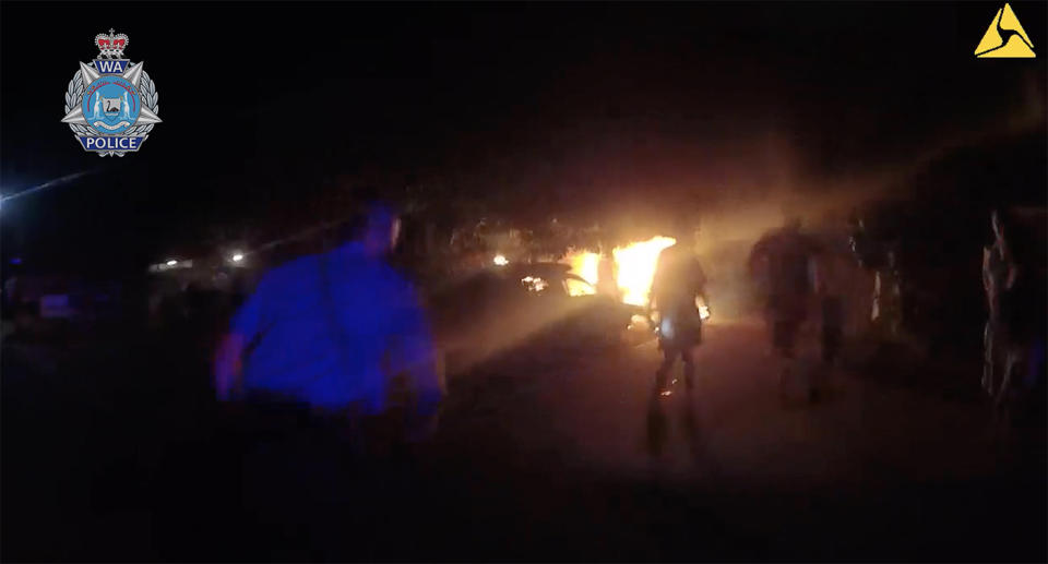 Body-camera vision shows a Western Australia police officer rushing toward a burning home with a child inside.