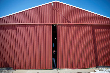 Soybean farmer Austin Rincker closes the door of a building housing his planter in Moweaqua, Illinois, U.S., March 6, 2019. REUTERS/Daniel Acker/Files