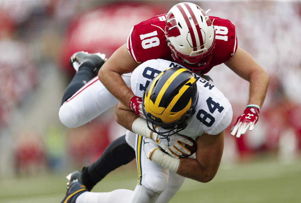 Wisconsin Badgers safety Collin Wilder (18) tackles Michigan Wolverines tight end Sean McKeon (84) during the third quarter on Sept. 21. (Getty)