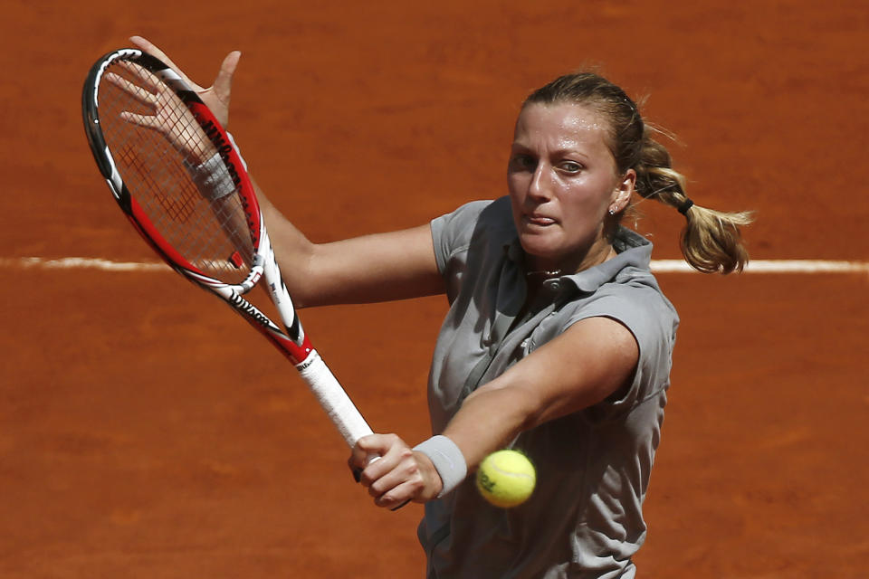 Petra Kvitova from the Czech Republic returns the ball during a Madrid Open tennis tournament semifinal match against Simona Halep from Romania in Madrid, Spain, Saturday, May 10, 2014. (AP Photo/Andres Kudacki)