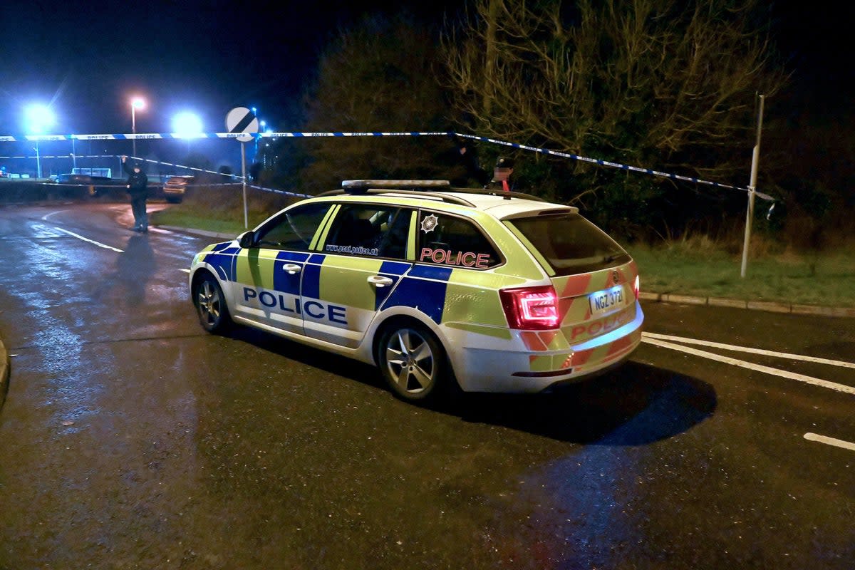 Police at the scene of a shooting in the Killyclogher Road area of Omagh (PA)