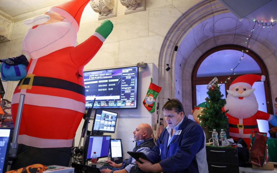 Traders work on the trading floor at the New York Stock Exchange (NYSE) in New York City, - Reuters
