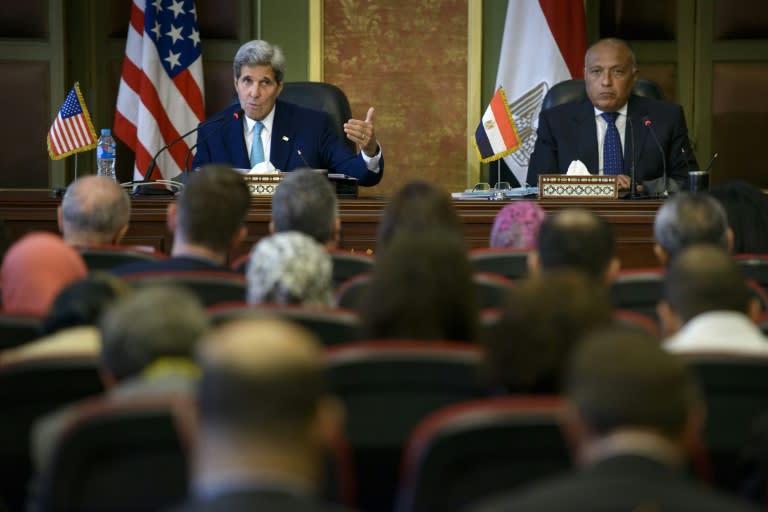 Egypt's Foreign Minister Sameh Shoukry (R) listens as US Secretary of State John Kerry delivers a speech on August 2, 2015 in Cairo