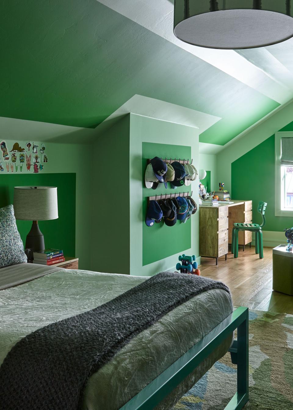 This son’s bedroom occupies a cozy attic space. “He wanted green walls,” says Liss. “The ceilings were so low that we decided to paint them green too, and created geometric shapes.” The designer used Sherwin Williams’s Envy and Relish shades.