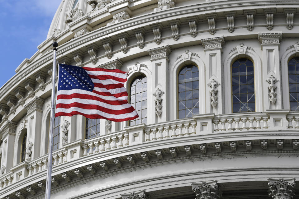 The American flag flies on Capitol Hill in Washington, Tuesday, March 17, 2020. (AP Photo/Susan Walsh)