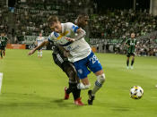 Austin FC defender Jhohan Romaña, back, trips San Jose Earthquakes Benji Kikanovic during the second half of an MLS soccer match Saturday, Sept. 18, 2021, in Austin, Texas. San Jose won 4-3. (AP Photo/Michael Thomas)