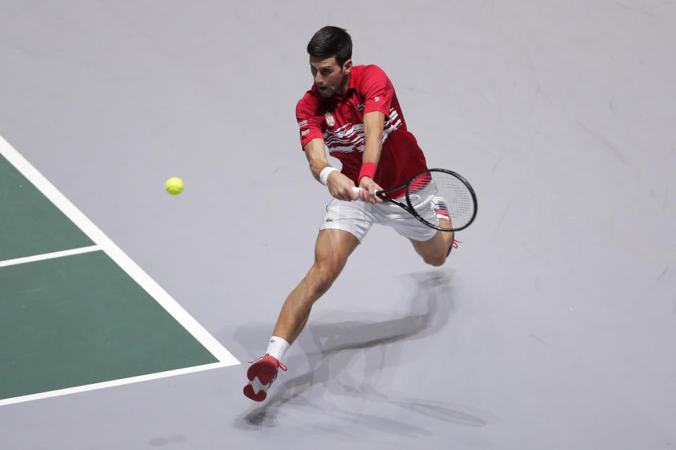 Serbia's Novak Djokovic returns the ball to Japan's Yoshihito Nishioka during their Davis Cup tennis match in Madrid, Spain, Wednesday, Nov. 20, 2019. (AP Photo/Manu Fernandez)