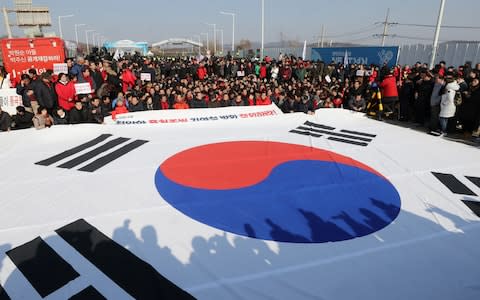 South Korean people attend a protest opposing Vice chairman of the North Korean ruling party's central committee Kim Yong Chol on the Grand Unification bridge - Credit: Reuters