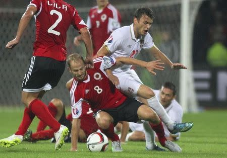 Albania's Migjen Basha (L) is tackled by Serbia's Adem Ljajic during their Euro 2016 Group I qualifying soccer match in Elbasan, Albania October 8, 2015. REUTERS/Arben Celi