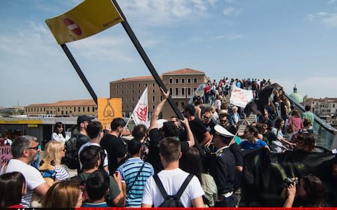 Protesters tried to dismantle one of the newly-installed barriers - Credit: Simone Padovani/Getty