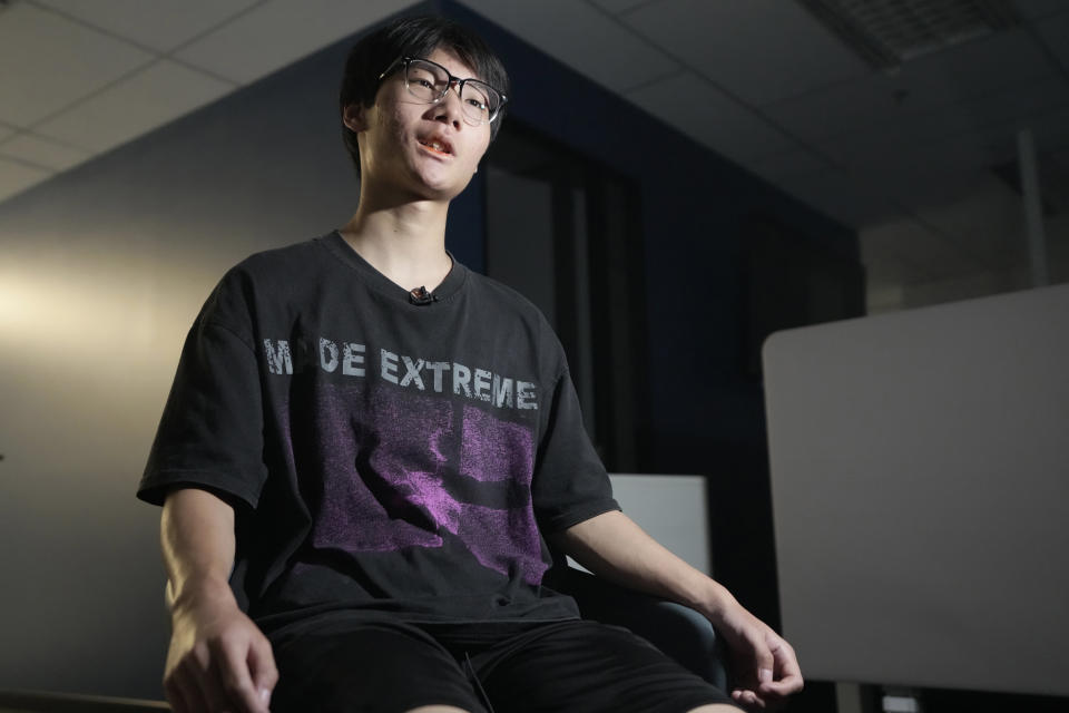 Gao Peng, son of Chinese dissident Gao Zhi, speaks during an interview with The Associated Press in Bangkok, Thailand, on July 17, 2023. Since landing in Thailand July 3, he says he has been accused of making bomb threats, put on an EU travel blacklist, and seem his mother and 16-year-old sister detained and threatened with deportation back to China. The threats, made in the family's names against airports, luxury hotels and the Chinese embassy in Bangkok derailed their plans to join Gao Zhi in the Netherlands. (AP Photo/Sakchai Lalit)