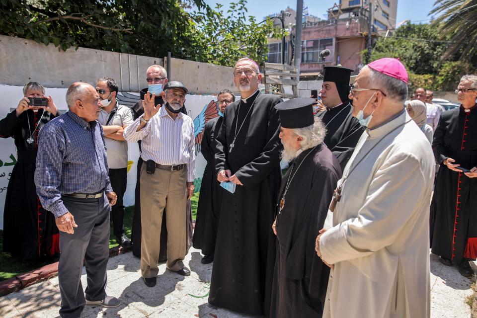 Latin Patriarch of Jerusalem Archbishop Pierbattista Pizzaballa (C), accompanied by Latin and Greek clergymen, is given a tour in the Israeli-annexed east Jerusalem neighborhood of Sheikh Jarrah, the site of regular protests against the expulsion of Palestinians from their homes in favor of Jewish settlers on July 28, 2021. 