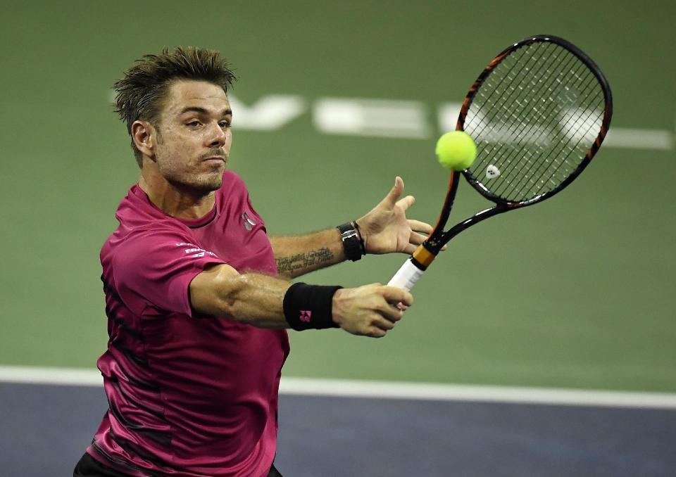 Stanislas Wawrinka, of Switzerland, returns a shot to Yoshihito Nishioka, of Japan, at the BNP Paribas Open tennis tournament, Wednesday, March 15, 2017, in Indian Wells, Calif. (AP Photo/Mark J. Terrill)