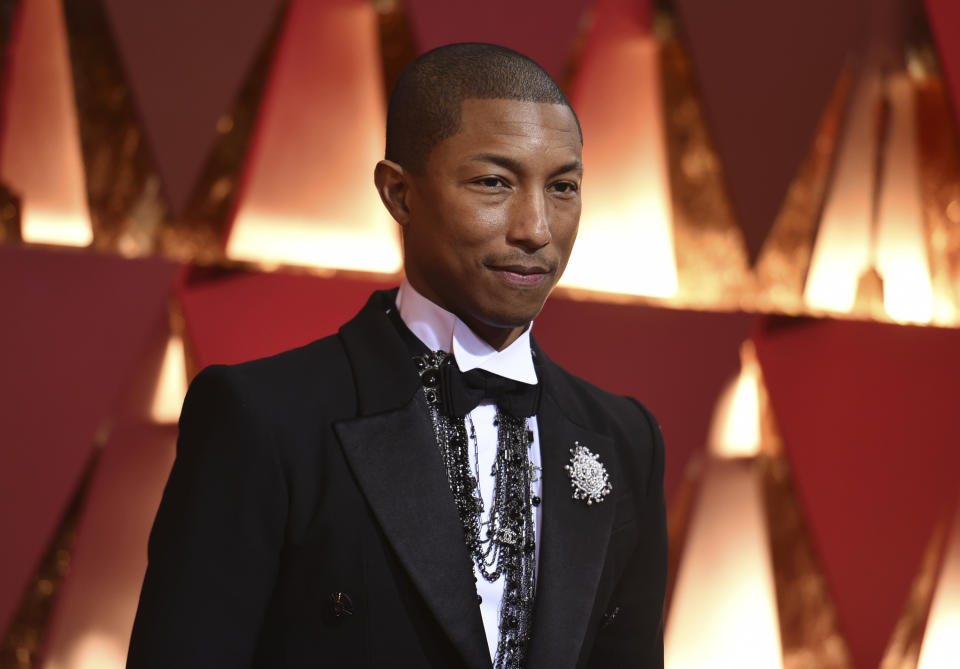 FILE - In this Feb. 26, 2017, file photo, Pharrell Williams arrives at the Oscars at the Dolby Theatre in Los Angeles. Cardi B, Pharrell, Kanye West were among the celebrities who fanned out across Miami for a week of glamorous parties toasting the world’s best artists during Art Basel. The prestigious extension of the annual contemporary art fair in Basel, Switzerland, officially opened Thursday, Dec. 6.(Photo by Richard Shotwell/Invision/AP, File)