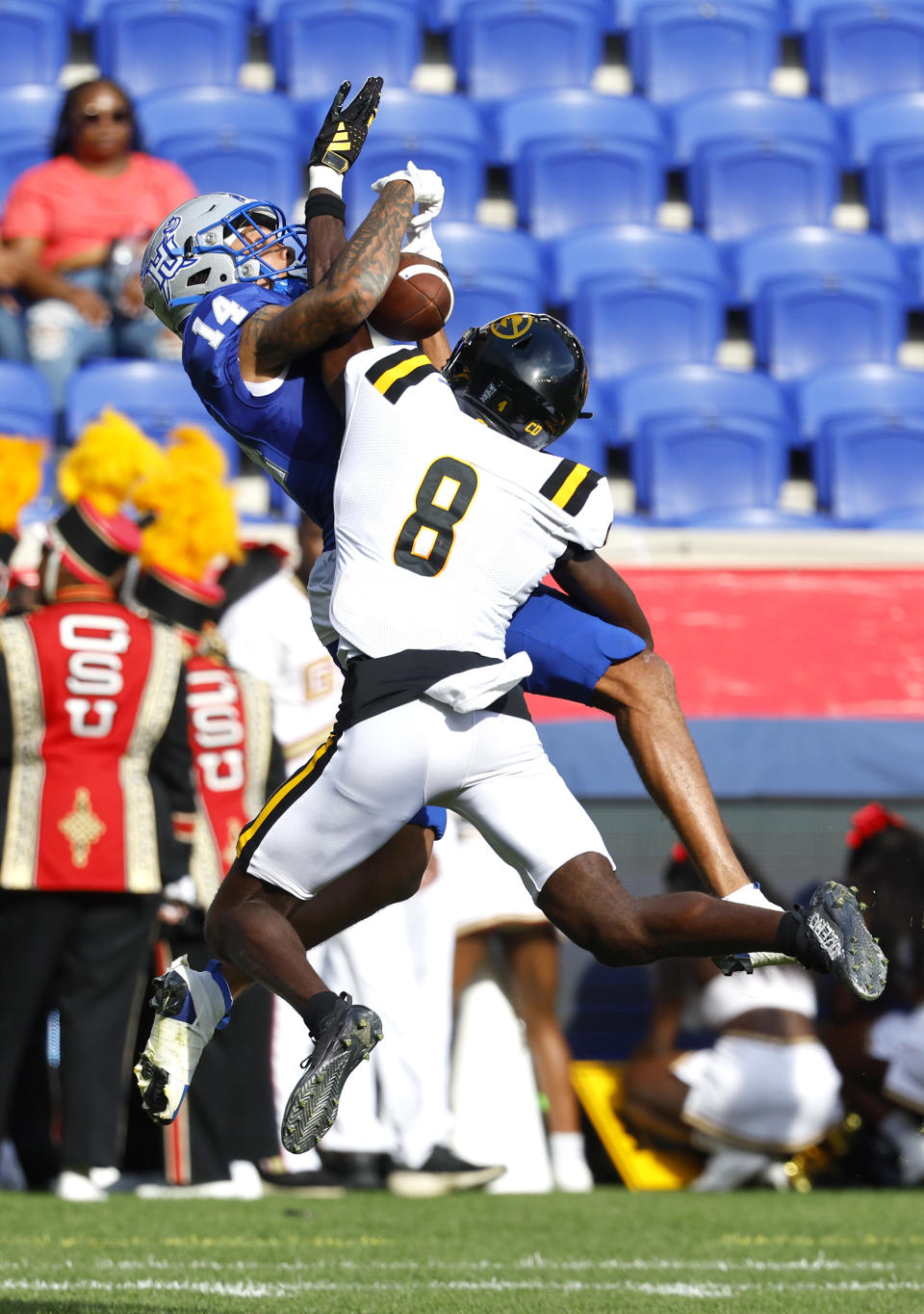 Grambling State Osiris Smith (8) takes the ball from Hampton wide receiver Armand Vinson (14) during the first half of an NCAA college football game, Saturday, Sept. 2, 2023, in Harrison, N.J. (AP Photo/Noah K. Murray)