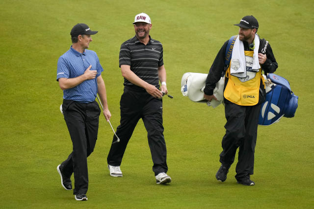Justin Rose, of England, and Michael Block walk on the 18th hole during the third round of the PGA Championship golf tournament at Oak Hill Country Club on Saturday, May 20, 2023, in Pittsford, N.Y. (AP Photo/Seth Wenig)