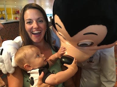 tarah and her child with mickey mouse at chef mickey's restaurant