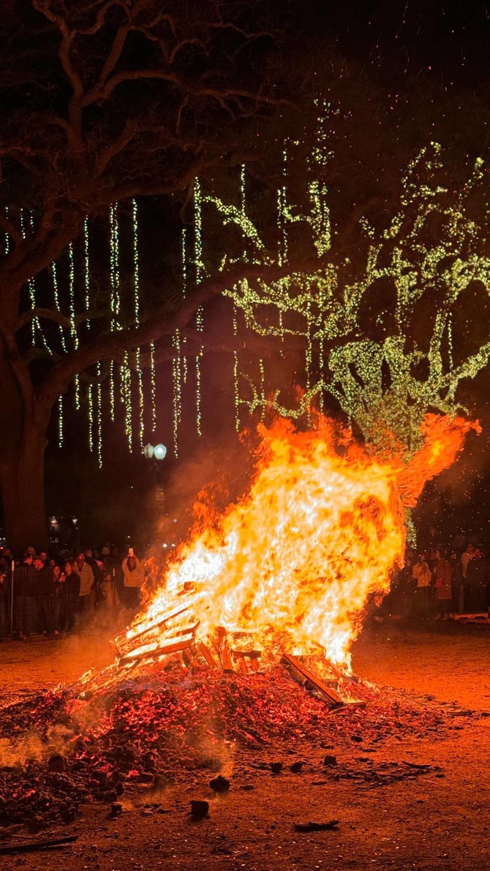 The giant bonfire throws flames into the air at Paso Robles’ New Year’s Eve celebration in the Downtown City Park on Dec. 31, 2023.