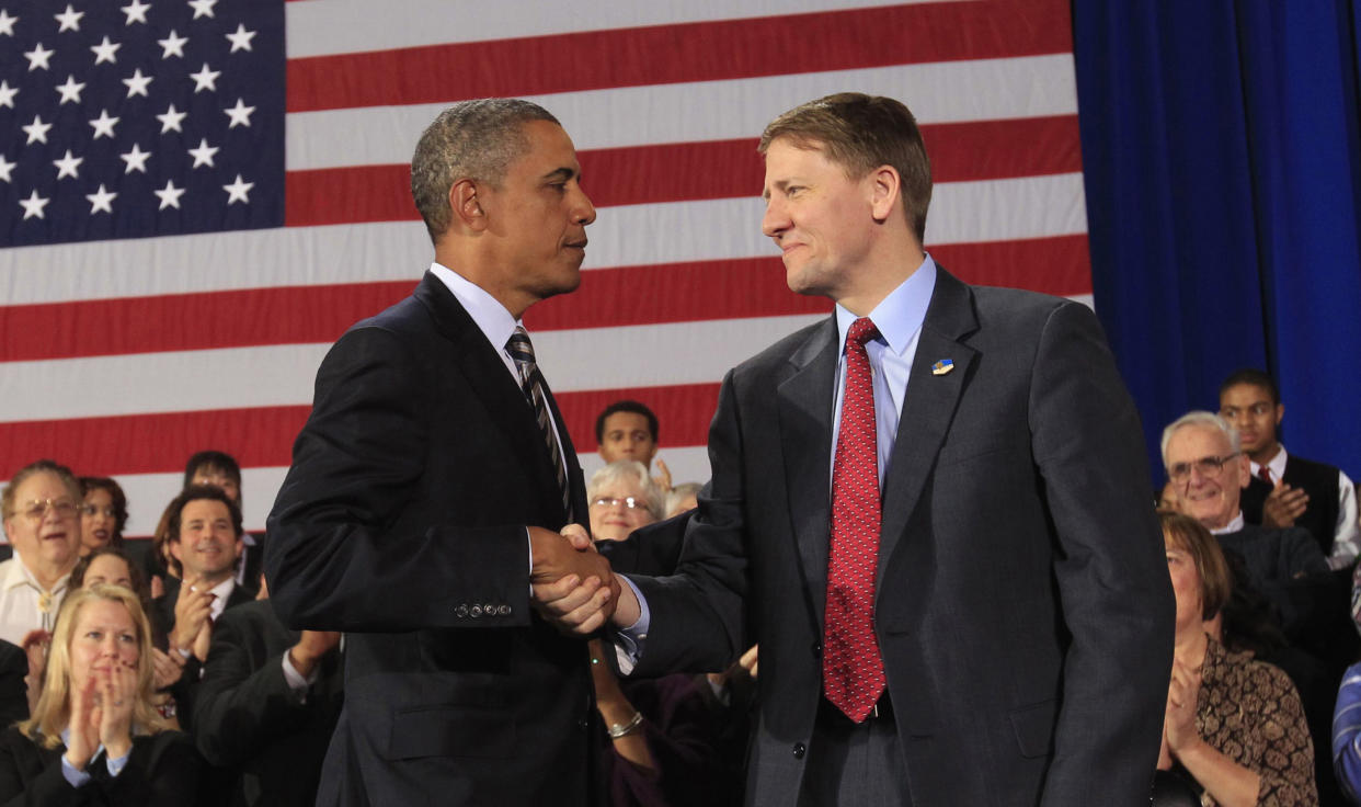 U.S. President Barack Obama shakes hands with Richard Cordray (R) after appointing him to head  the Consumer Financial Protection Bureau during a trip to Cleveland, Ohio January 4, 2012. Republicans hoping to be chosen to run against President Barack Obama in the 2012 election blasted him on January 5, 2012 for bypassing Congress to fill politically sensitive posts. Picture taken January 4, 2012.    REUTERS/Kevin Lamarque  (UNITED STATES - Tags: BUSINESS POLITICS)