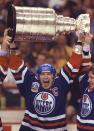 FILE - Edmonton Oilers captain Mark Messier holds up the Stanley Cup trophy after the Oilers beat the Boston Bruins in May 1990. No matter which team wins the Stanley Cup this year it will be a first this century. (AP Photo/CP, Ryan Remiorz, File)