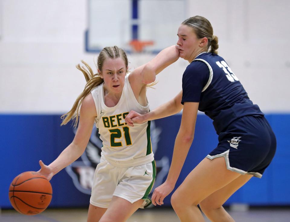 Medina's Izzy Kurka, left, drives past Hudson's Paige Sutton during a Division I district semifinal, Tuesday, Feb. 27, 2024, in Ravenna.