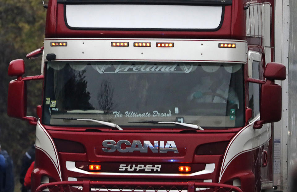 Police escort the truck, that was found to contain a large number of dead bodies, as they move it from an industrial estate in Thurrock, south England, Wednesday Oct. 23, 2019. Police in southeastern England said that 39 people were found dead Wednesday inside a truck container believed to have come from Bulgaria. (AP Photo/Alastair Grant)