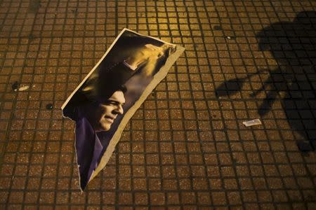 A torn poster of opposition leader and head of radical leftist Syriza party Alexis Tsipras is seen on a street near a place where far-right Golden Dawn party had a campaign rally in Athens, Greece in this January 21, 2015 file photo. REUTERS/Marko Djurica/Files