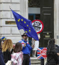 Anti-Brexit protesters demonstrate outside the Cabinet Office in Whitehall in London on Thursday, Aug. 15, 2019. Demonstrations for both sides of the Brexit debate continue around parliament, as Prime Minister Boris Johnson has vowed that Britain will leave the EU on Oct. 31, with or without a Brexit deal. (AP Photo/ Vudi Xhymshiti)