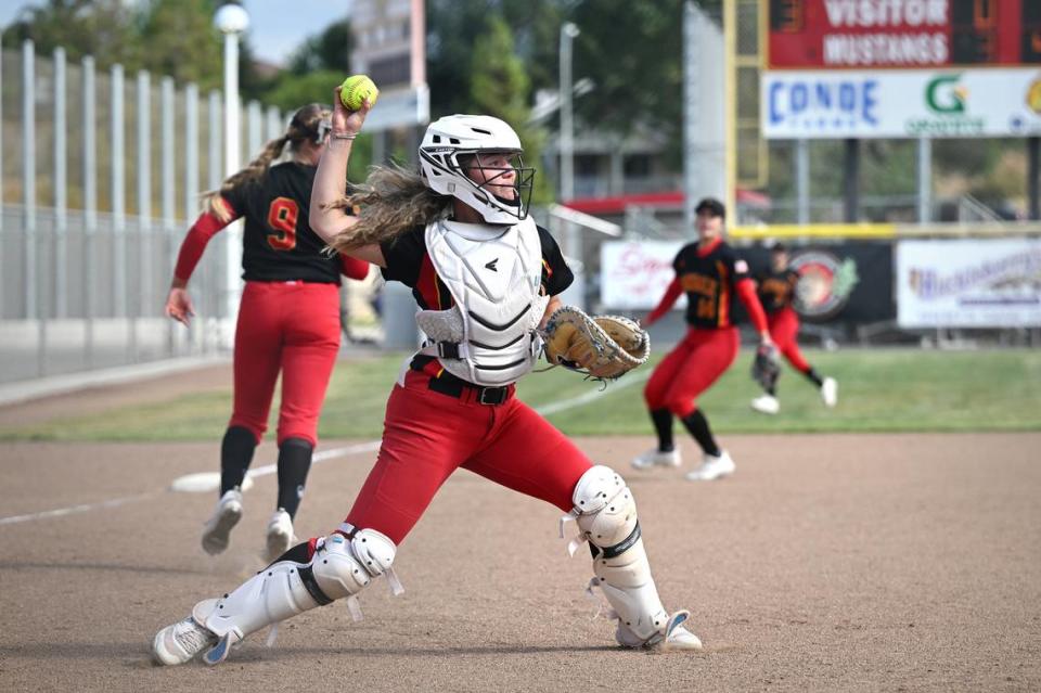 Oakdale catcher Presley Barnes fields a bunt and attempts a throw out at first during the Valley Oak League game with Kimball in Oakdale, Calif., Thursday, May 4, 2023.