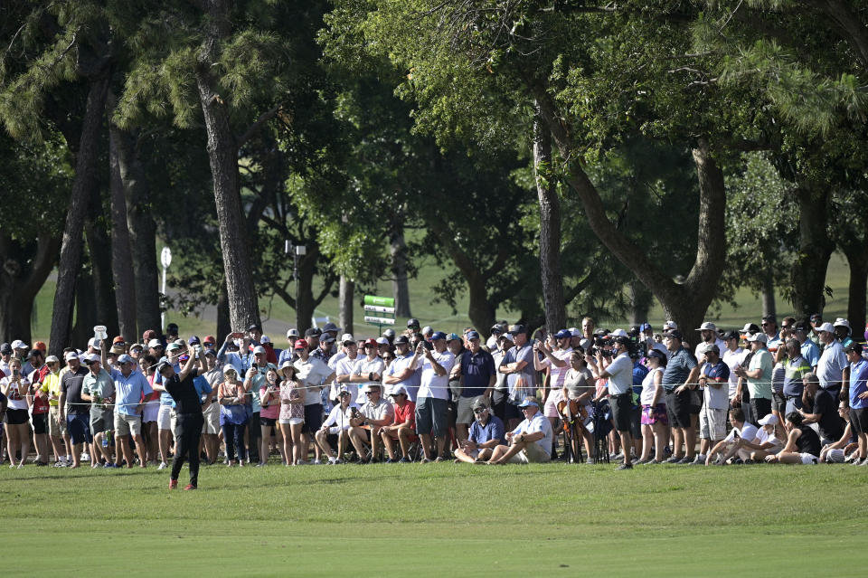 Spectators watch as Keegan Bradley hits from the 16th fairway during the final round of the Valspar Championship golf tournament, Sunday, May 2, 2021, in Palm Harbor, Fla. (AP Photo/Phelan M. Ebenhack)