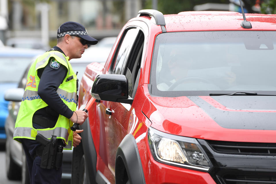 Police check permits at Griffith Street checkpoint at Coolangatta on the Gold Coast. Source: AAP