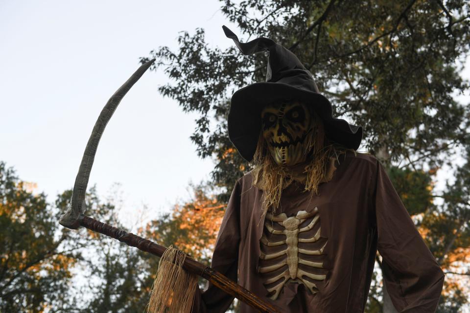 A large scarecrow stands outside the Williams house on Robin Road on Tuesday, Oct. 17, 2023.