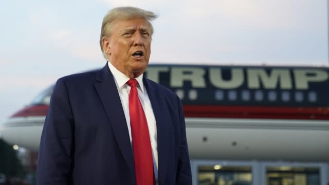 Former President Donald Trump speaks with reporters before departure from Hartsfield-Jackson Atlanta International Airport.