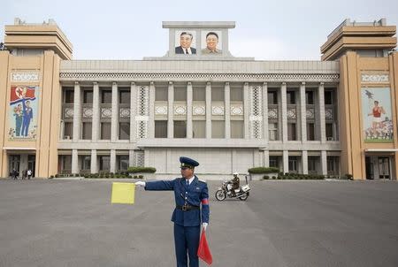 A policeman directs traffic at the Kim Il Sung Stadium before North Korea's preliminary 2018 World Cup and 2019 AFC Asian Cup qualifying soccer match against Philippines in Pyongyang October 8, 2015. REUTERS/Damir Sagolj