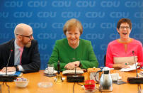 Secretary General of the Christian Democratic Union (CDU) Peter Tauber, German Chancellor Angela Merkel and Saarland State Prime Minister Annegret Kramp-Karrenbauer ahead CDU leadership meeting in Berlin, Germany, February 19, 2018. REUTERS/Hannibal Hanschke