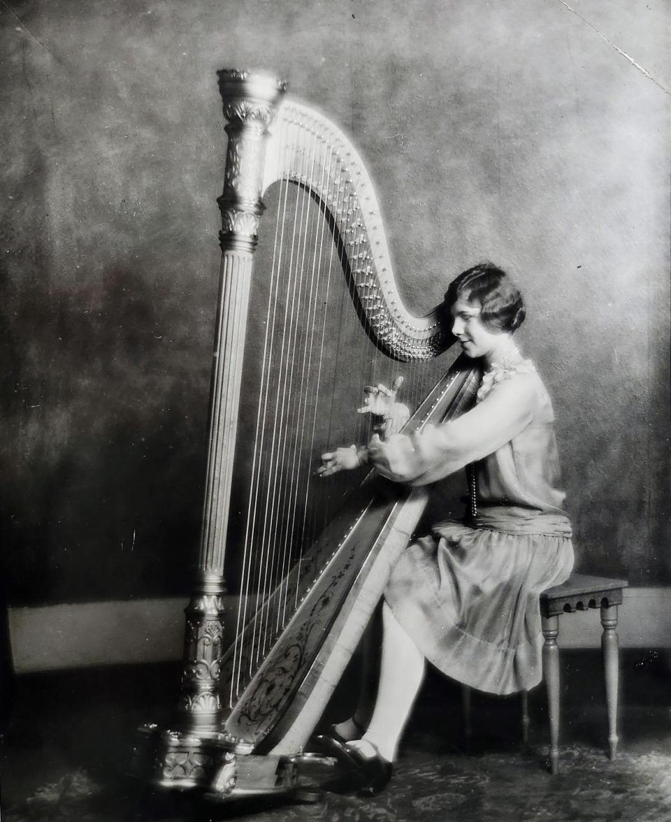 An undated photo shows Dorothy Steidte playing the harp at Riverside High School. Students will be playing harps again at the MPS Biennial Music Festival this May.