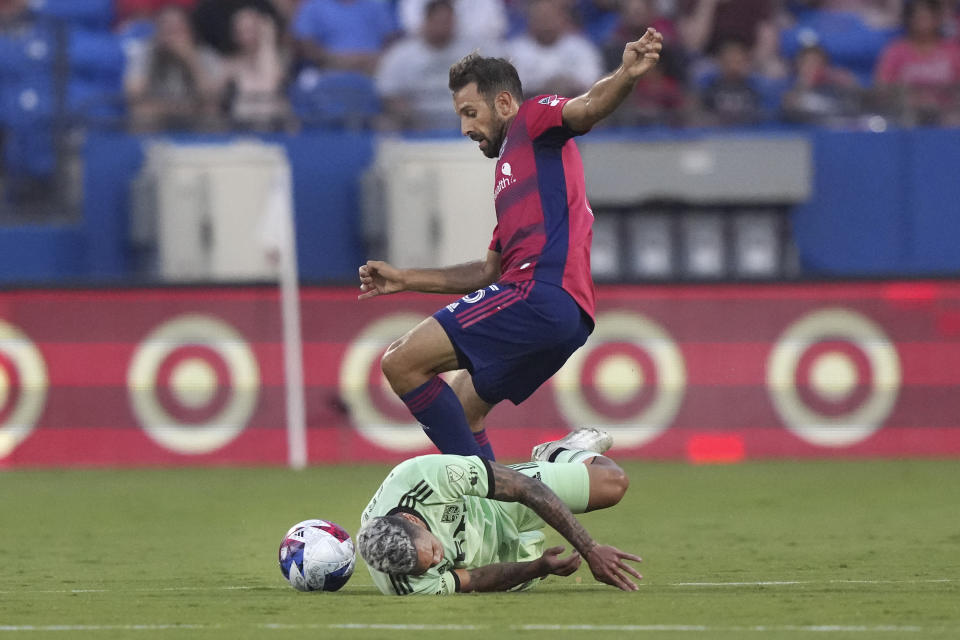 Austin FC midfielder Daniel Pereira (6) falls to the pitch next to FC Dallas midfielder Facundo Quignon (5) during the first half of an MLS soccer match Saturday, Aug. 26, 2023, in Frisco, Texas. (AP Photo/LM Otero)