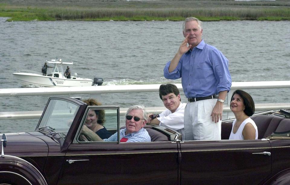 Actor Andy Griffith drives his 1935 Packard convertible over the newly-opened Virginia Dare Memorial Bridge as North Carolina Gov. Mike Easley stands up in the back of the vehicle in August 2002 in Manteo, N.C. Also shown, from background left, are Griffith’s wife, Cindi, North Carolina Attorney General Roy Cooper, and Easley’s wife, Mary.