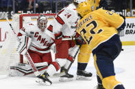 Carolina Hurricanes goaltender Petr Mrazek (34) blocks a shot by Nashville Predators defenseman David Farrance (22) during the second period of an NHL hockey game Monday, May 10, 2021, in Nashville, Tenn. (AP Photo/Mark Zaleski)