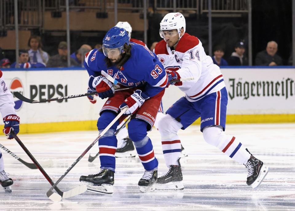 NEW YORK, NEW YORK - APRIL 07: Mika Zibanejad #93 of the New York Rangers holds the stick belonging to Nick Suzuki #14 of the Montreal Canadiens during the second period at Madison Square Garden on April 07, 2024 in New York City.