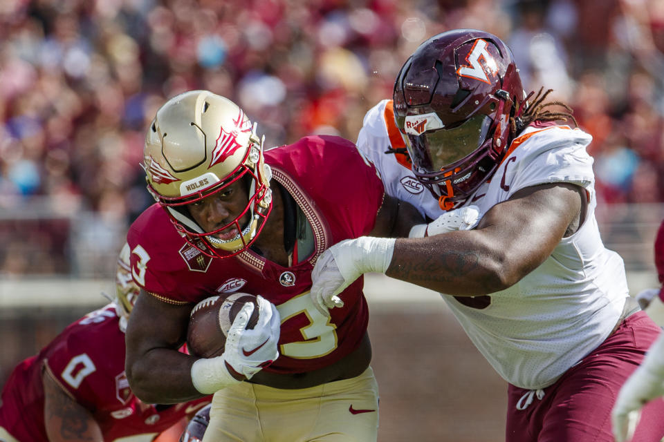 Florida State running back Trey Benson (3) pushes away from Virginia Tech defensive lineman Norell Pollard (3) during the first half of an NCAA college football game, Saturday, Oct. 7, 2023, in Tallahassee, Fla. (AP Photo/Colin Hackley)