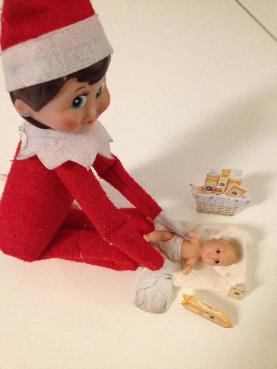 The Elf changes baby doll diapers!  (Lexie Van Winkle)