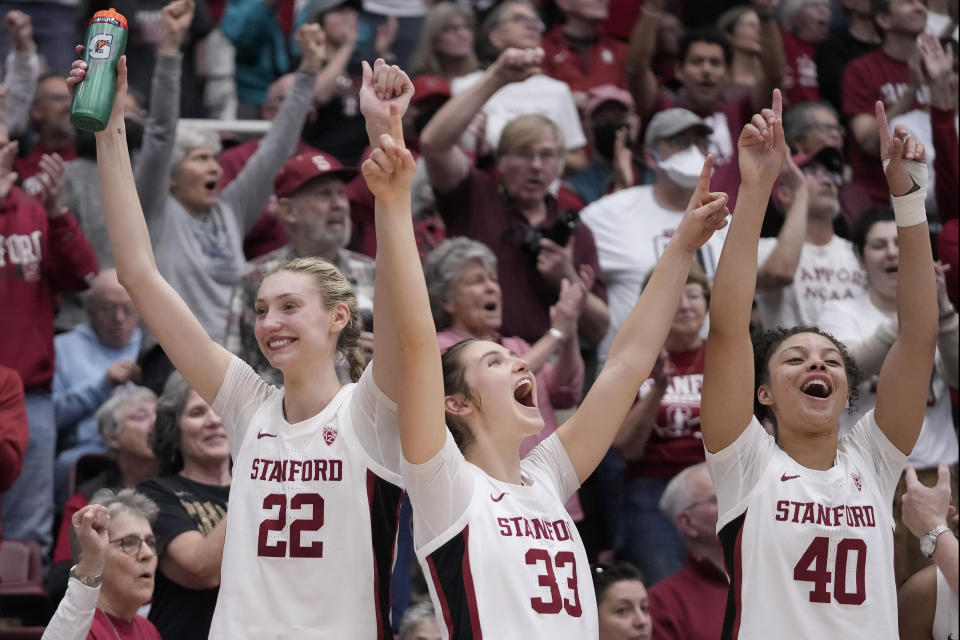 Stanford's Cameron Brink (22), guard Hannah Jump (33) and forward Courtney Ogden (40) celebrate after winning at least a share of the Pac-12 title Sunday. (AP Photo/Jeff Chiu)